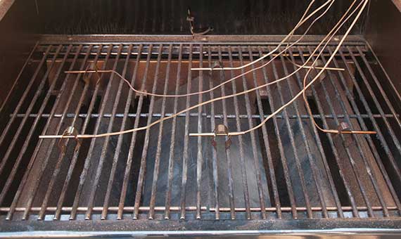 Barbecue grill grate with wires attached