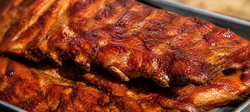 Two full racks of Tuscan ribs on a plate.
