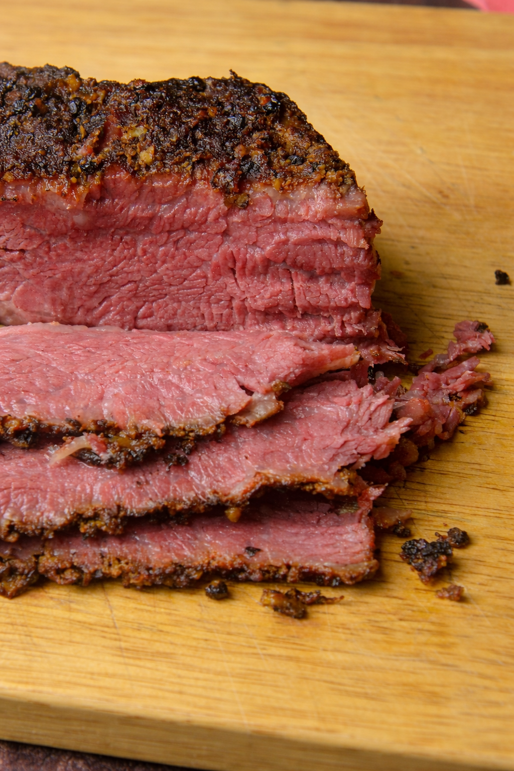 smoked pastrami sliced on wooden board
