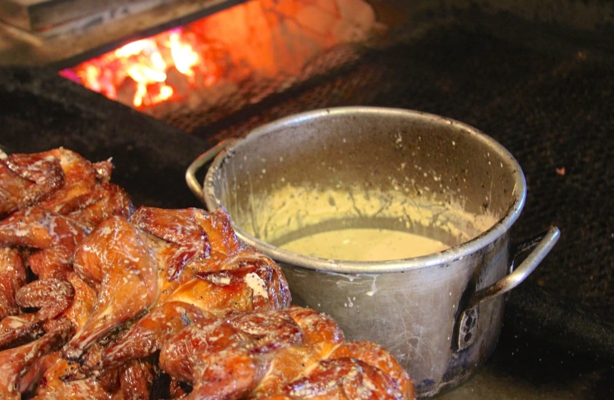 Chickens dunked in Alabama white BBQ sauce at Big Bob Gibsons