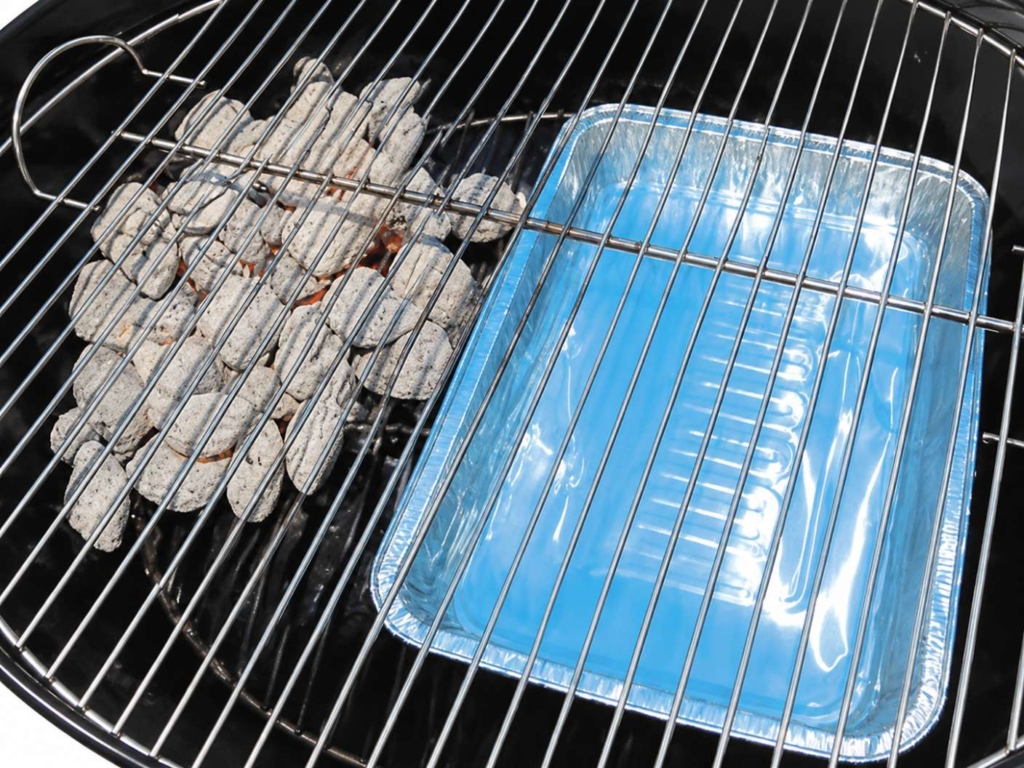 Foil waterpan and charcoal in a grill