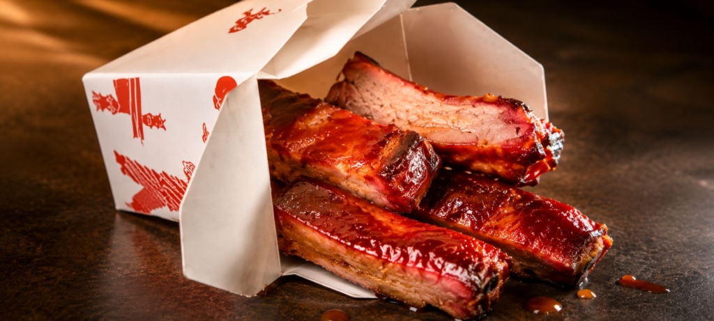 Char siu ribs in Chinese food takeout container.