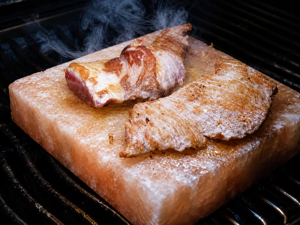 Meat being cooked on a salt block