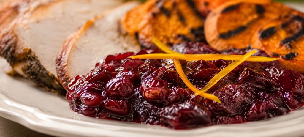 Cranberry sauce with turkey and grilled sweet potato slices.