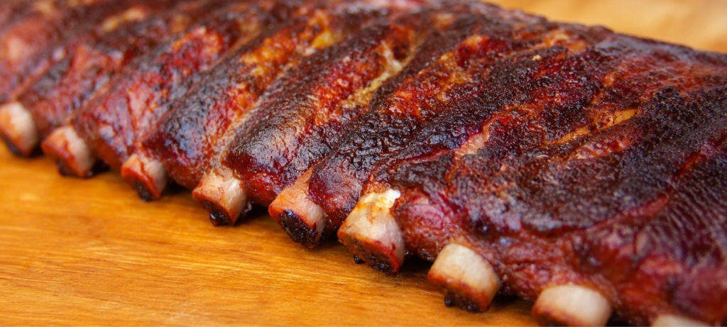 Memphis dry rubbed ribs on a wood cutting board