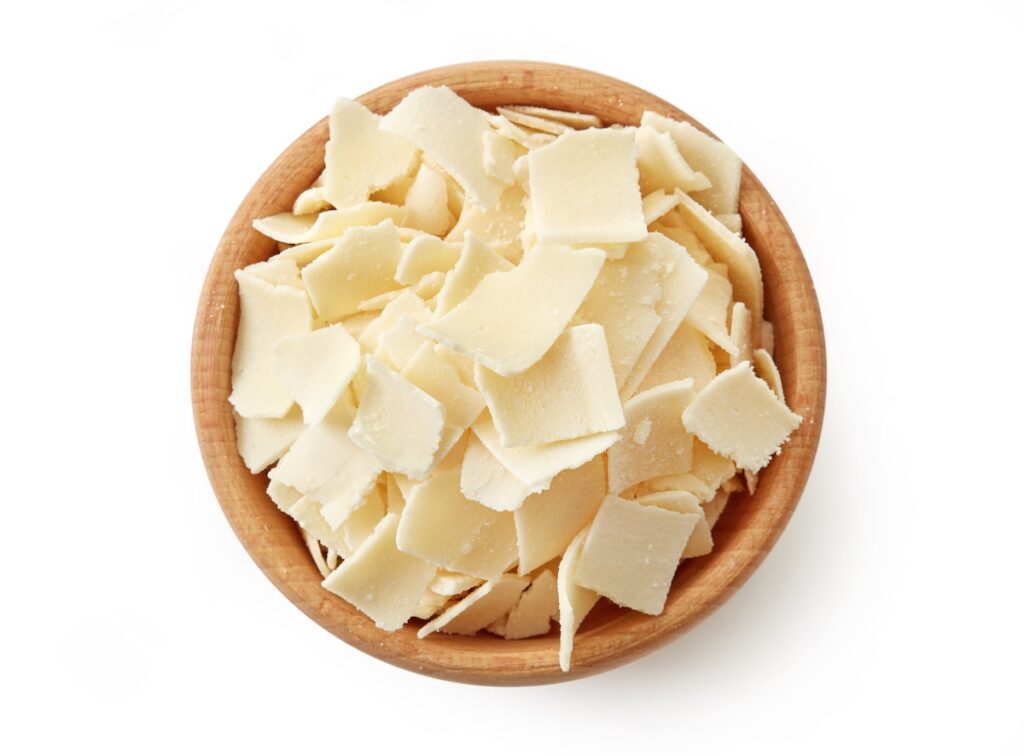 shaved parmesan cheese in a wooden bowl.