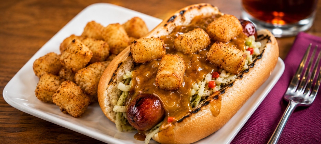 Polish sausage on bun topped with slaw, musrad BBQ sauce, and tater tots.