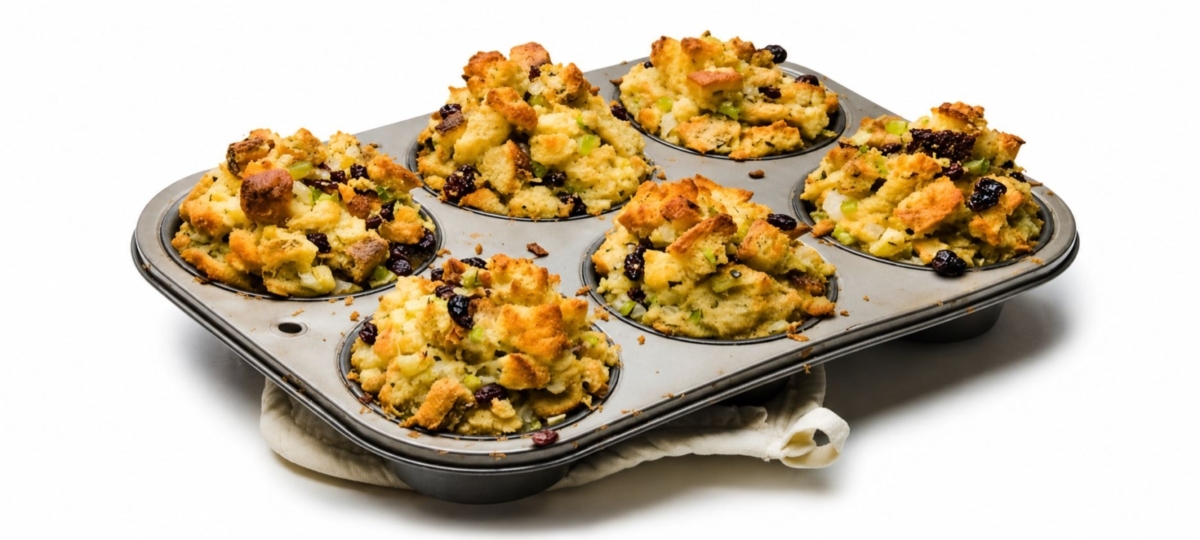 Stuffing muffins in a muffin tin.