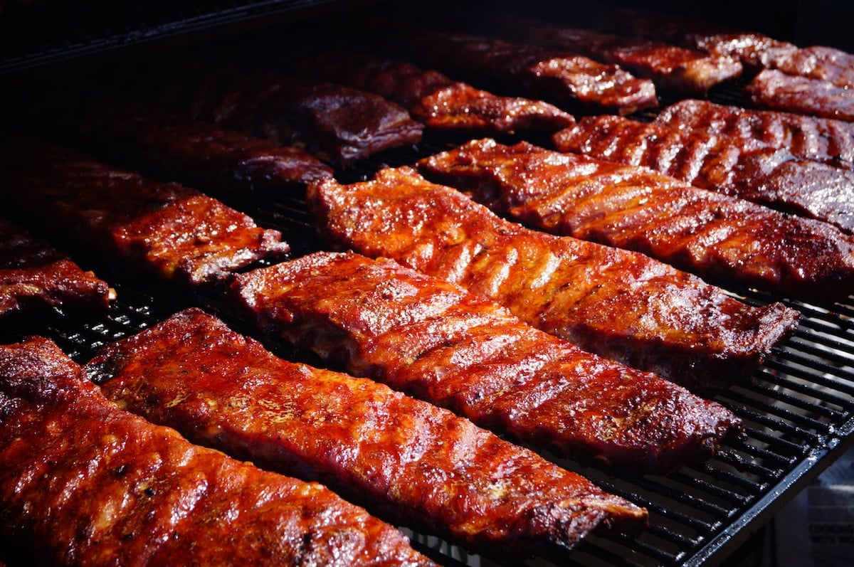 Slabs of BBQ ribs on a smoker