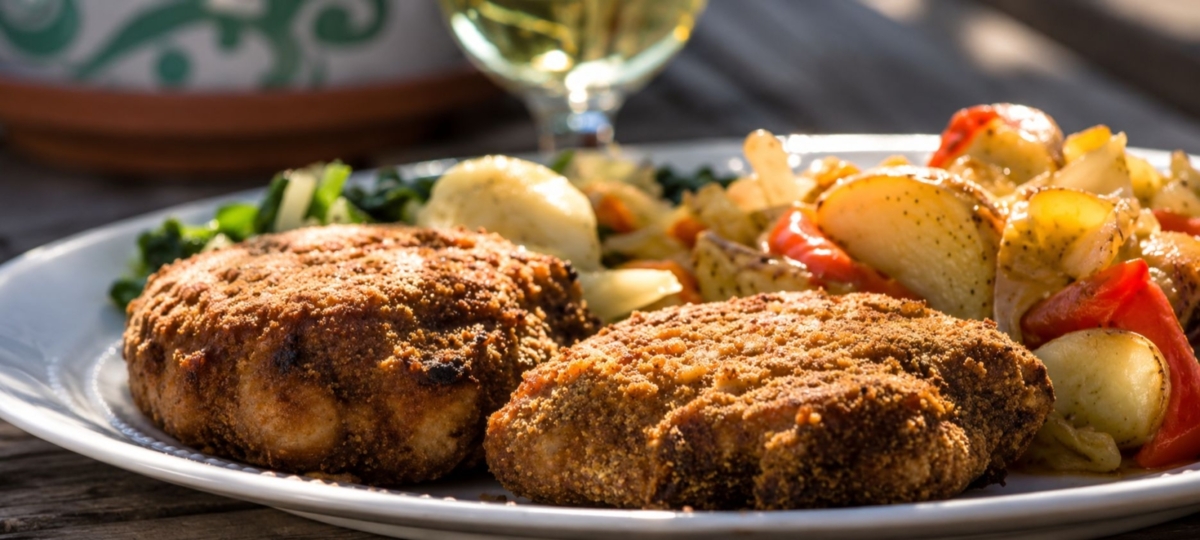 Plated breadcrumb crusted chicken with vegetables