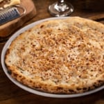 Frank Pepe's White Clam Pizza on a pizza tray