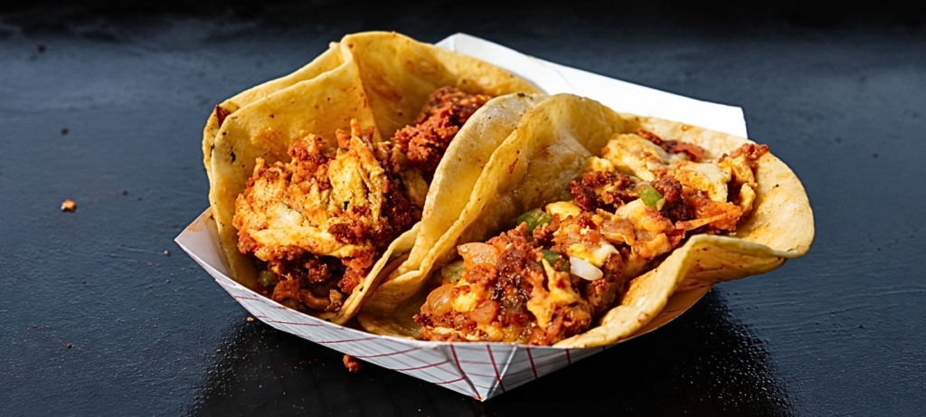 Two breakfast tacos in paper boat