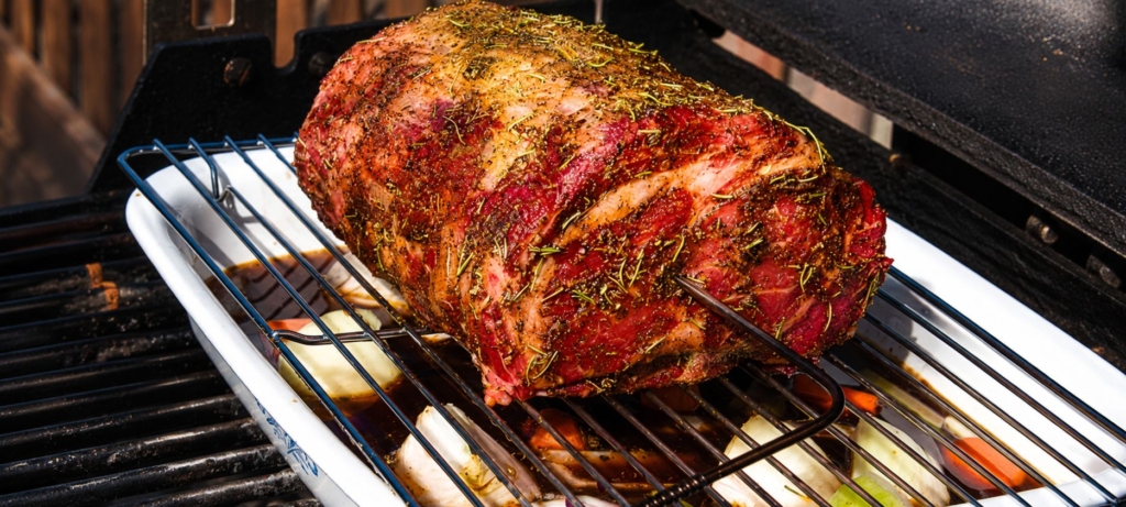 Grilled prime rib on a grill grate.