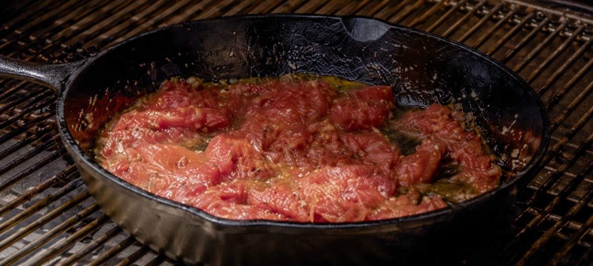 Heating tomato sauce in a skillet