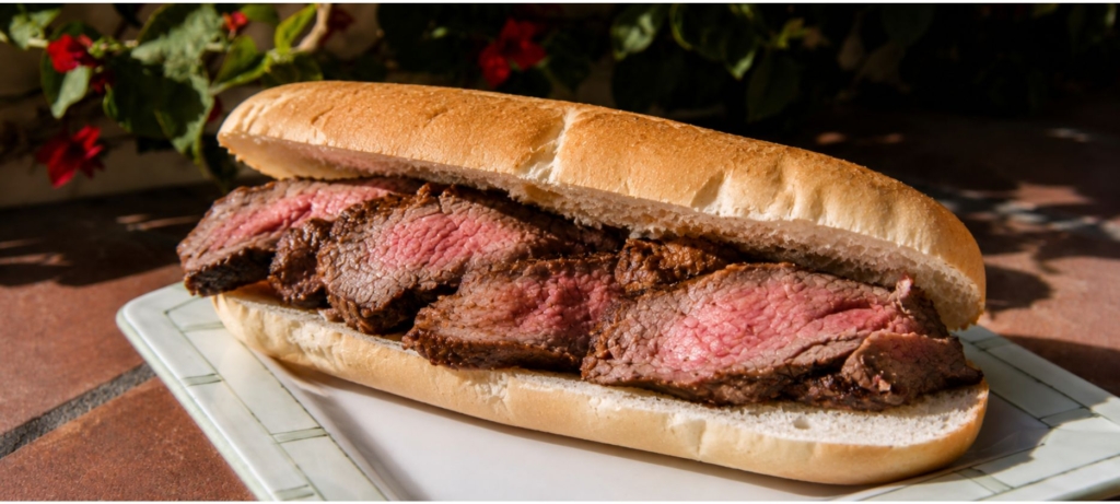 Plated sliced Santa Maria tri-tip on a roll
