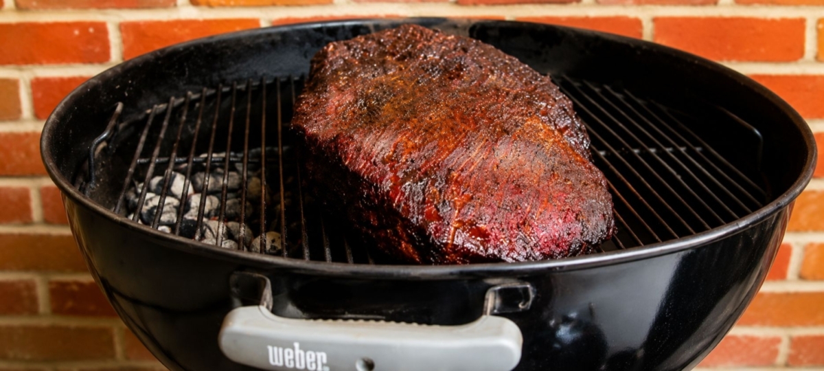 Smoked whole brisket on a kettle charcoal grill.