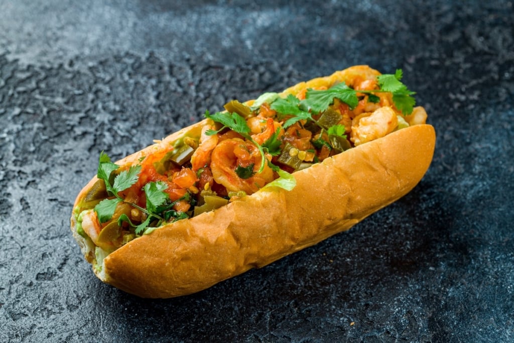 shrimp andouille po boy sandwich on a dark background