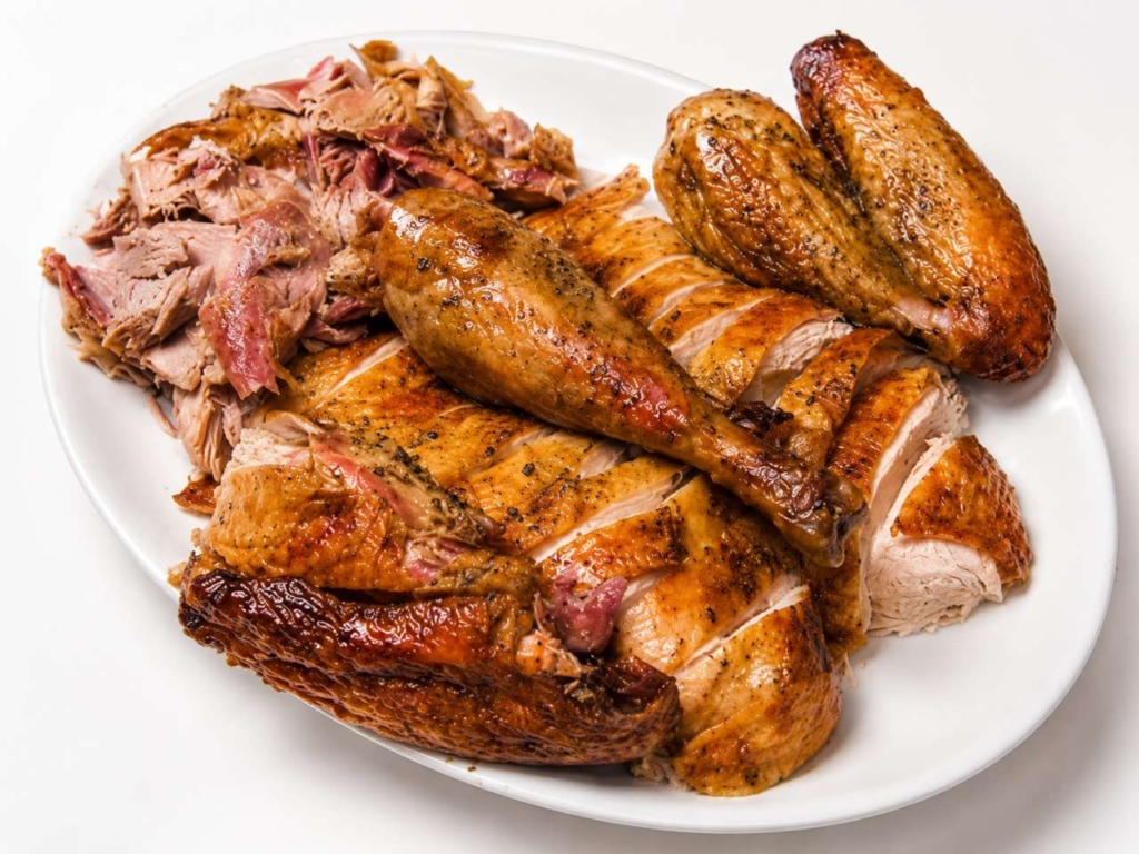 Carved turkey on a white platter.