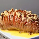 Hasselback sweet potato with maple pecan butter on a plate