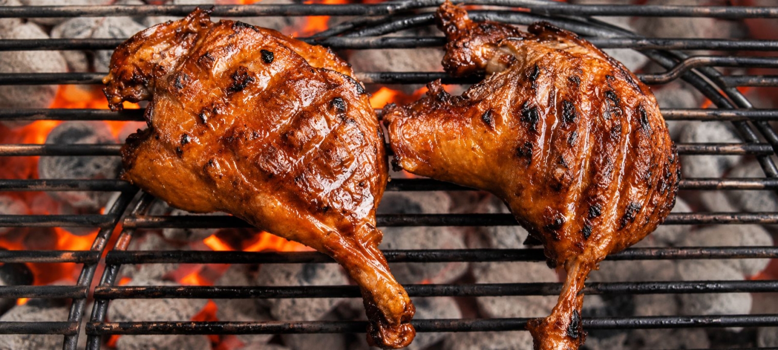 Two duck quarters on a grill.
