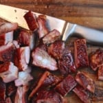chopped smoked pork tips and a knife on a cutting board