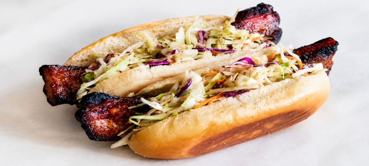 Bacon hot dogs featuring thick cut bacon and slaw on hot dog buns