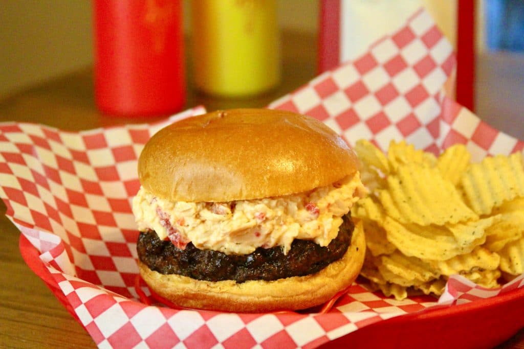 Pimento cheese burger on plate with potato chips
