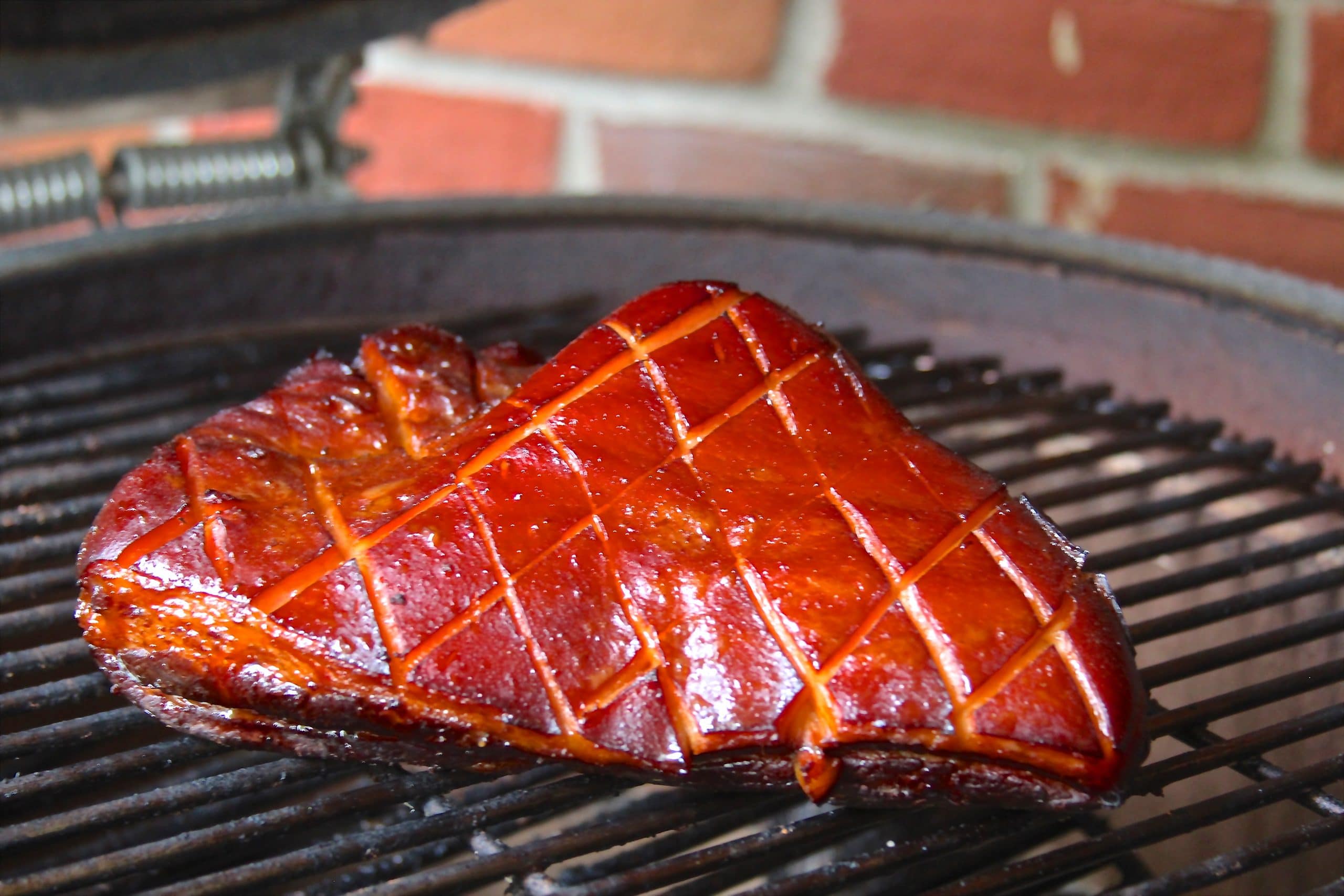 Sous vide and smoked pork belly on a grill