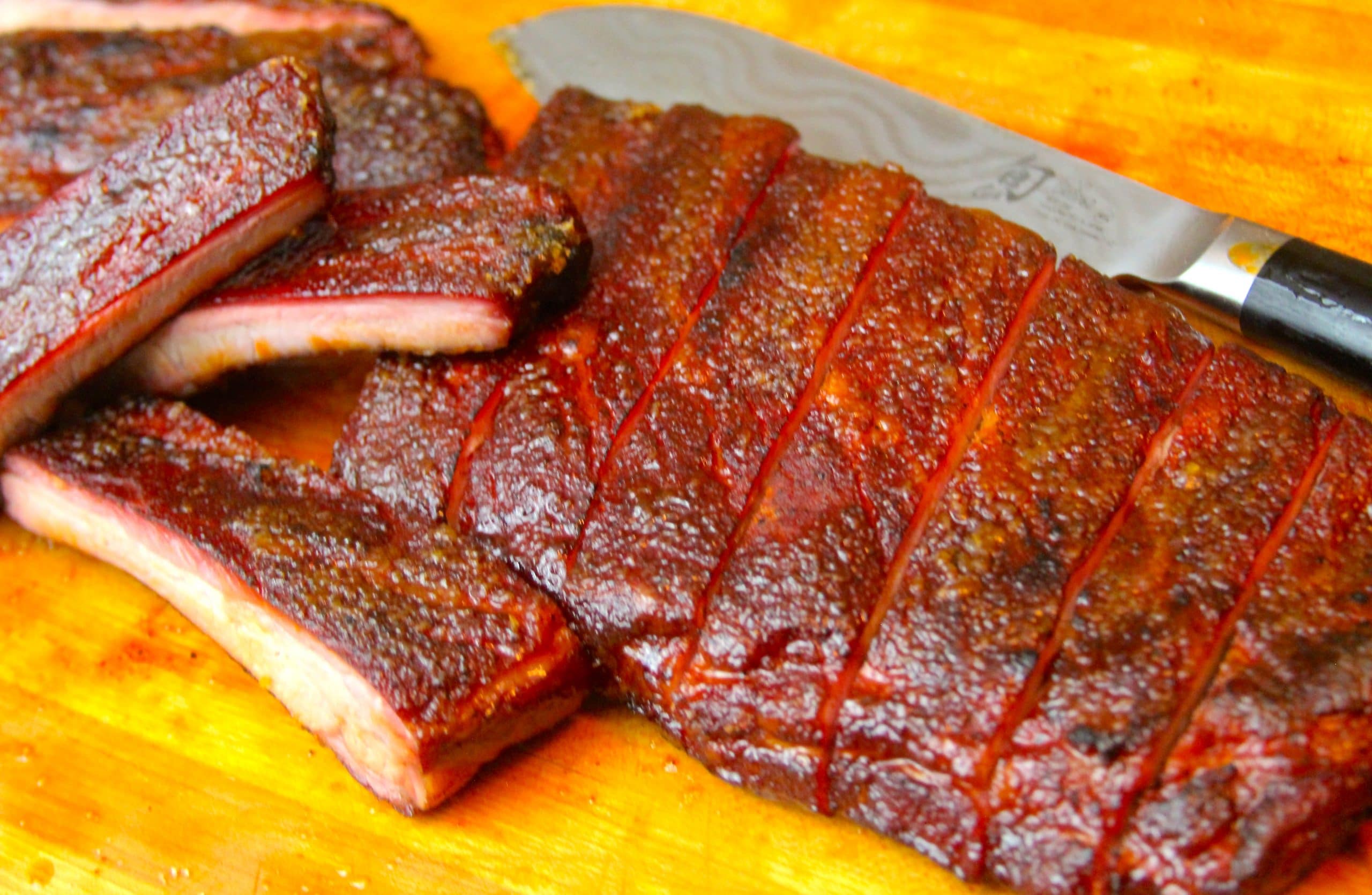 Candied ribs sliced on a cutting board
