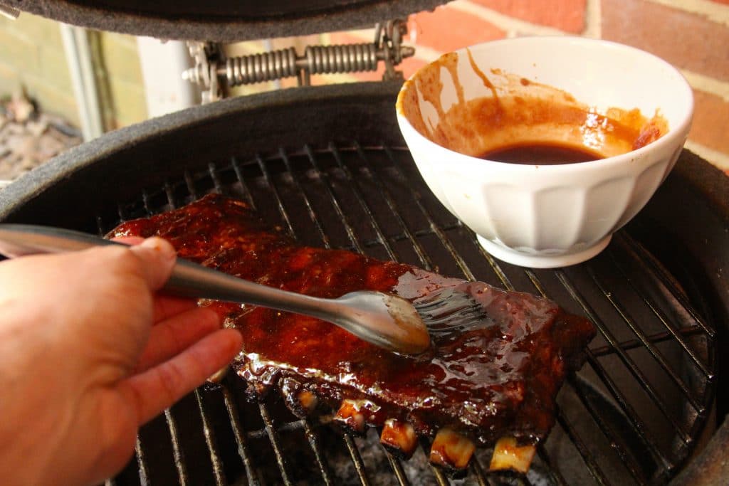 Saucing ribs with soy-ginger glaze