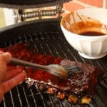 Saucing ribs with soy-ginger glaze