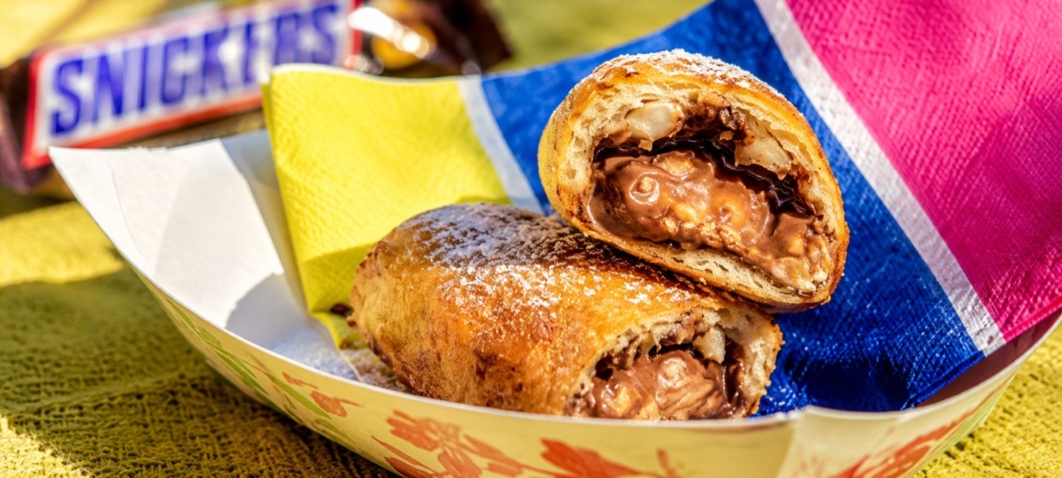 Deep fried snickers in paper boat.