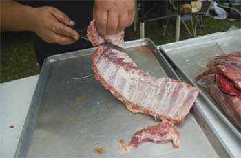 trimming the ribs to fit in the smoker