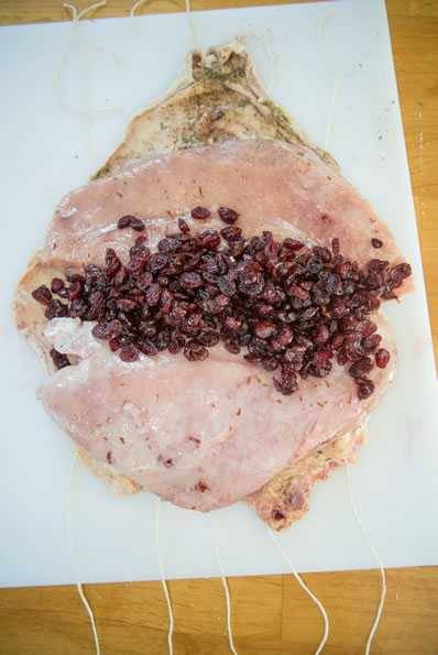 Drunken cranberry stuffing piled onto boneless turkey breast