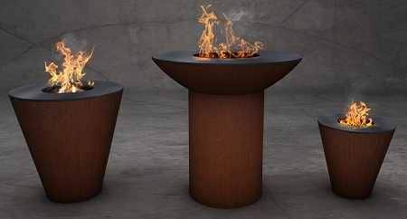 Three beautiful rust colored fire bowls with flames leaping from the centers.