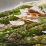 Grilled asparagus spears topped with cheese shavings