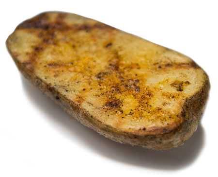 Grill marks crisscross a halved baked potato