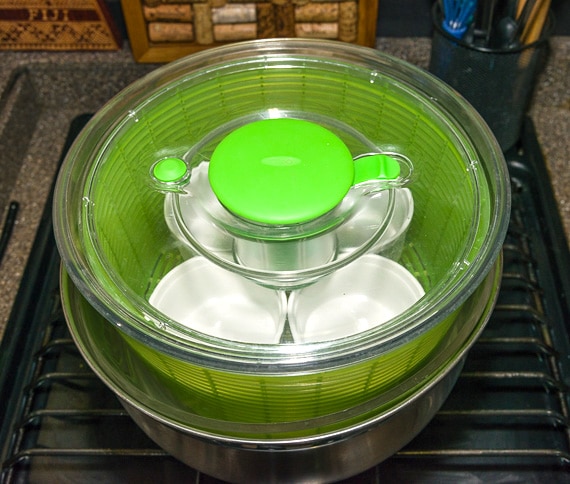 ramekins set inside salad spinner set in a pot
