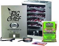 Shiny metal box with front removed. "Big Chief" is printed on the front. Inside we see racks loaded with meat jerky. A green plastic bag of wood chips sits on the right.
