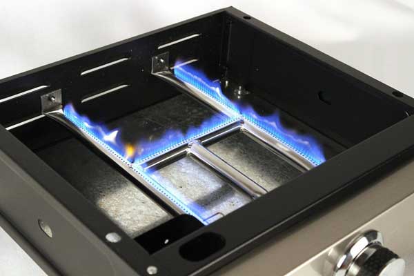 H-shaped gas burner inside a metal box. Blue flames burn.
