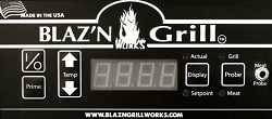 Black rectangular control module with various button and an LED display. "Blaz'n Grill Works" is printed on the top in white letters.