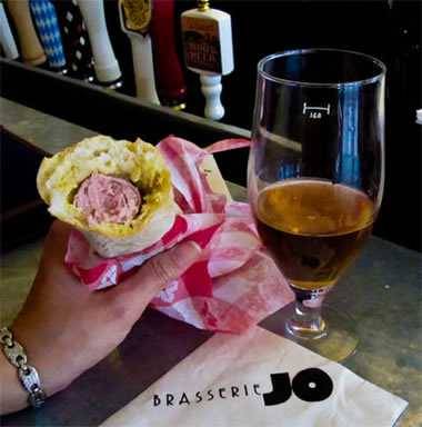 eating chien blanc sausage at Brasserie Jo