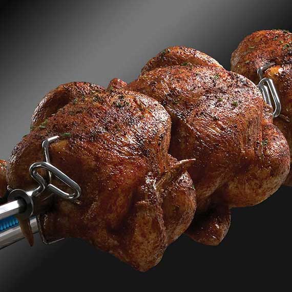 Chicken roasting on a rotisserie spit.