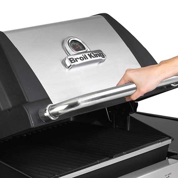 A hand lifts the lid of a gas BBQ grill.