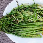 grilled asparagus and scallions on a white plate