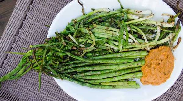 grilled calcots and romesco sauce on a plate