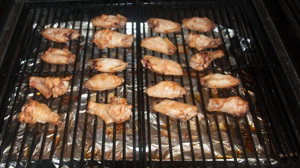 Chicken wings cooking on a grill
