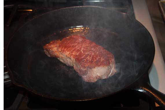 Steak searing in a cast iron skillet