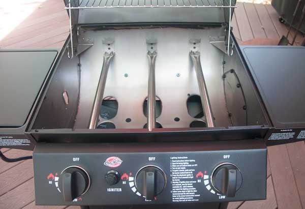 gas grill with lid open showing 3 tube burners