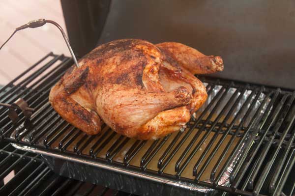 golden brown chicken cooking on a grill